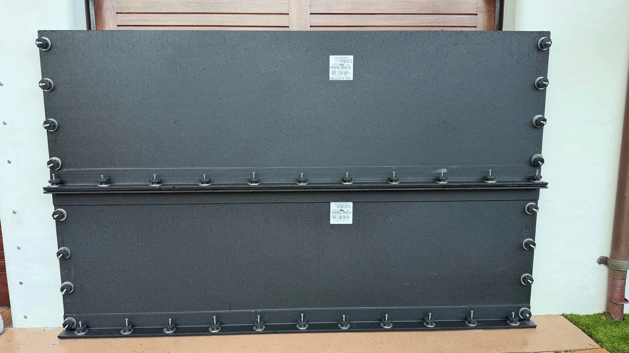 Deployed flood panels forming a continuous line across the terrace